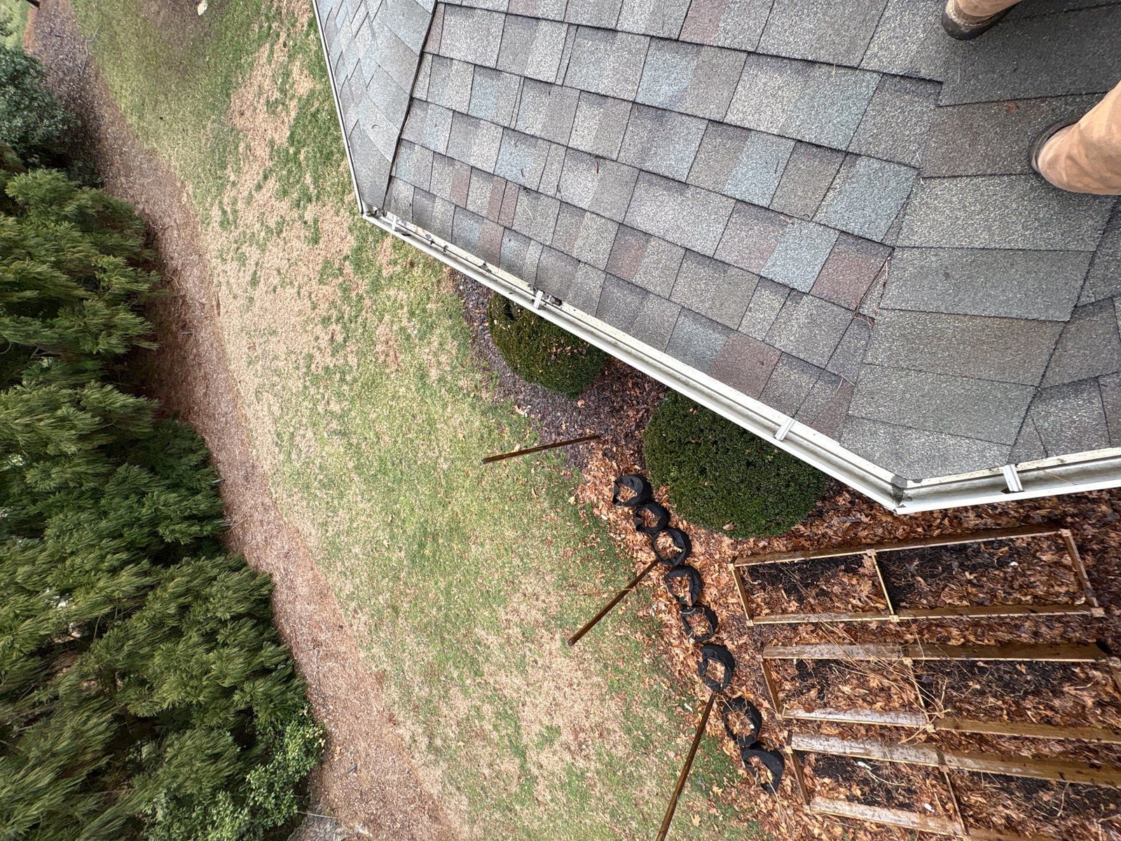 Exterior residential gutter cleaning and downspout debris removal