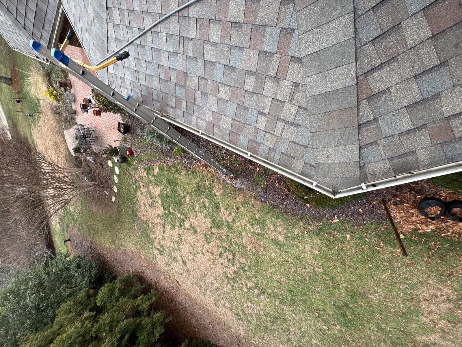 Exterior residential gutter cleaning and downspout debris removal