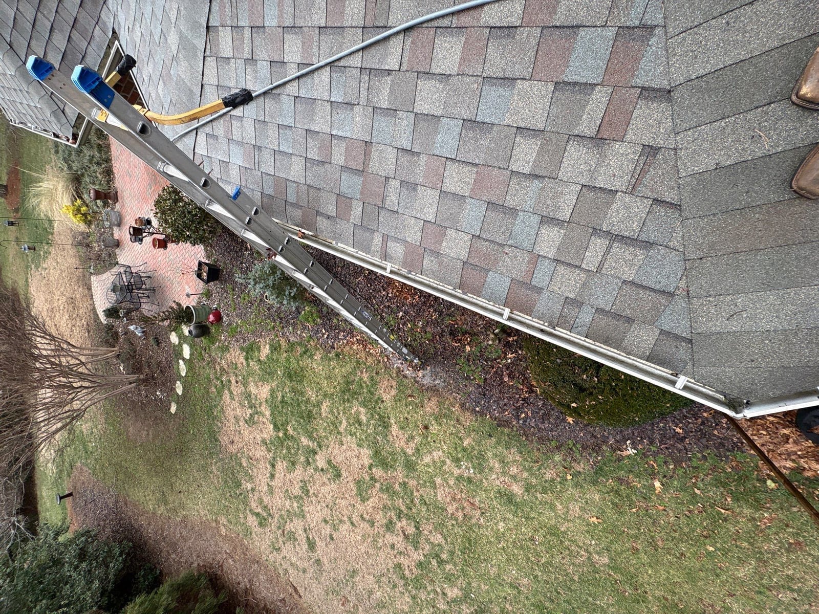 Exterior residential gutter cleaning and downspout debris removal
