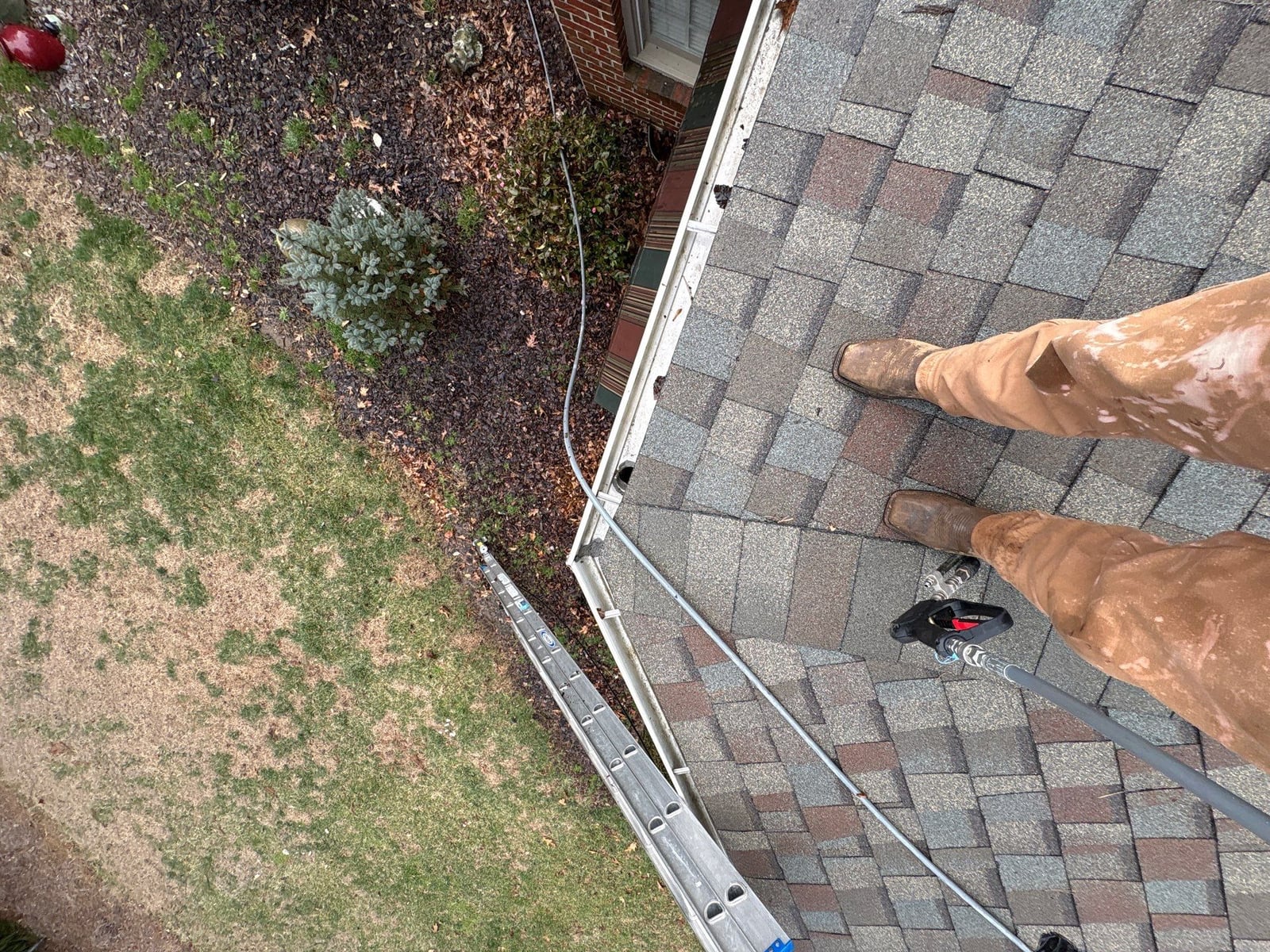 Exterior residential gutter cleaning and downspout debris removal