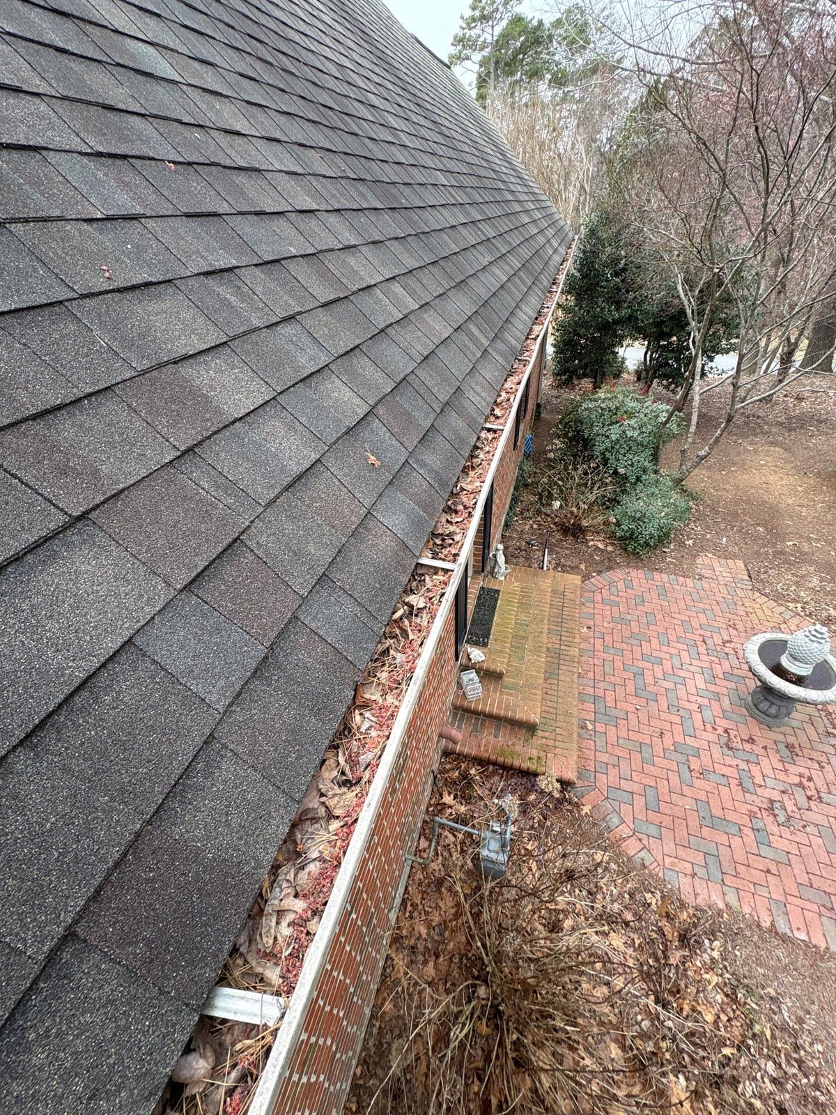 Exterior residential gutter cleaning and downspout debris removal