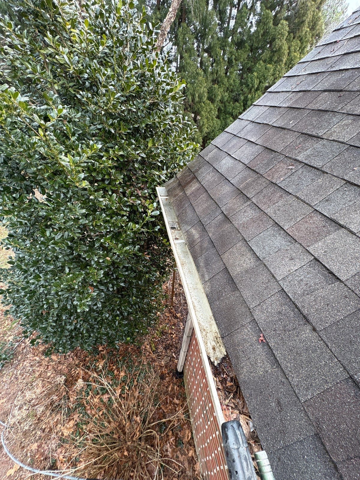 Exterior residential gutter cleaning and downspout debris removal