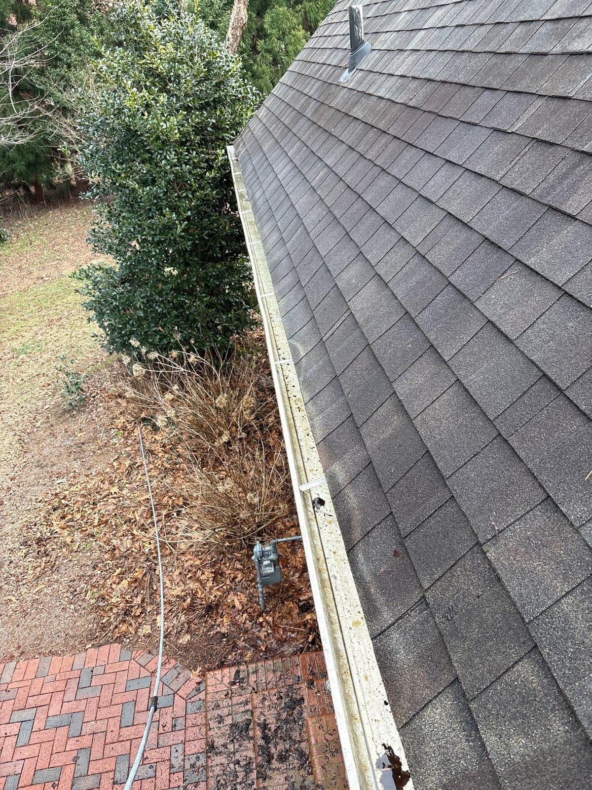 Exterior residential gutter cleaning and downspout debris removal