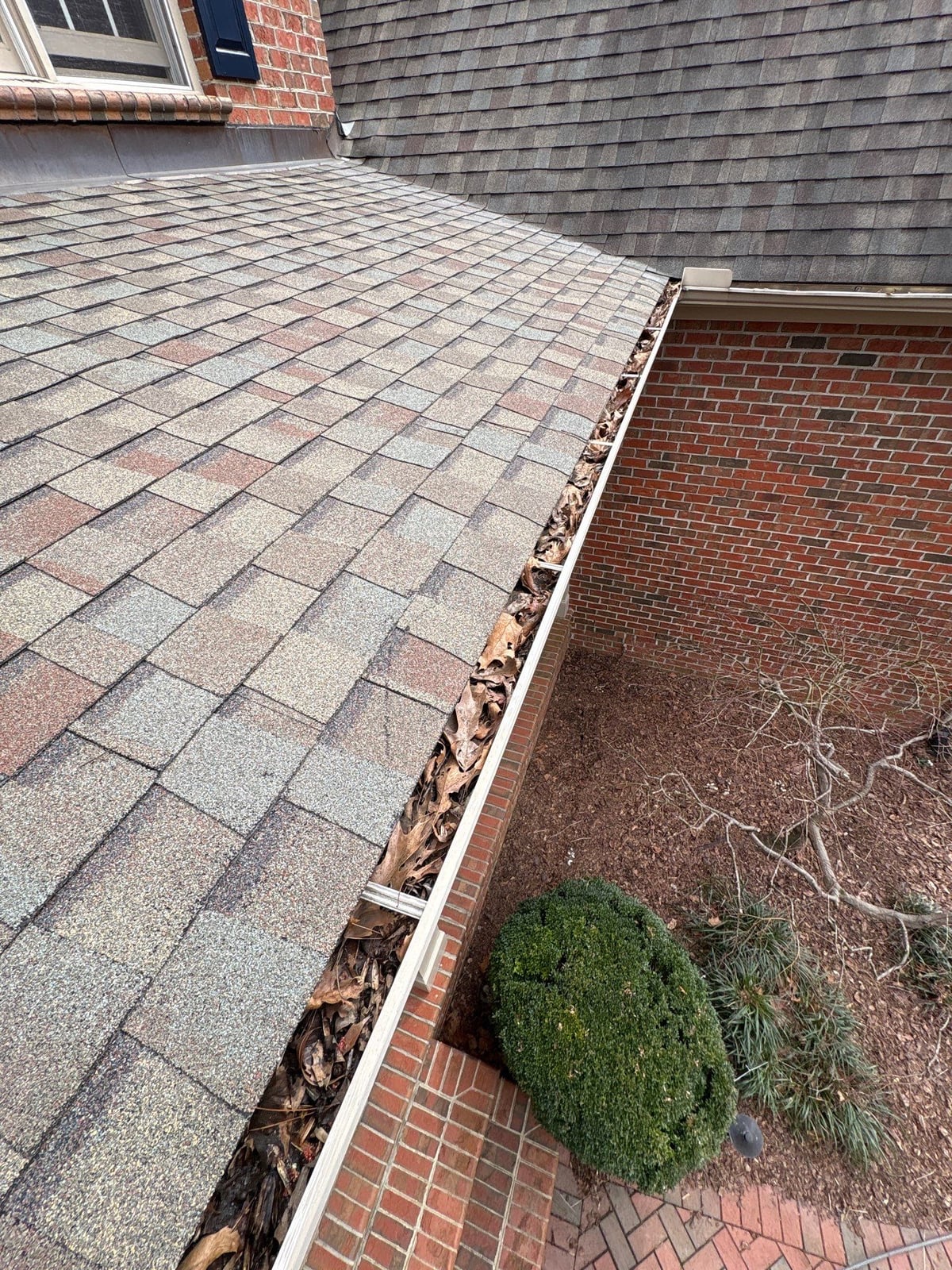 Exterior residential gutter cleaning and downspout debris removal