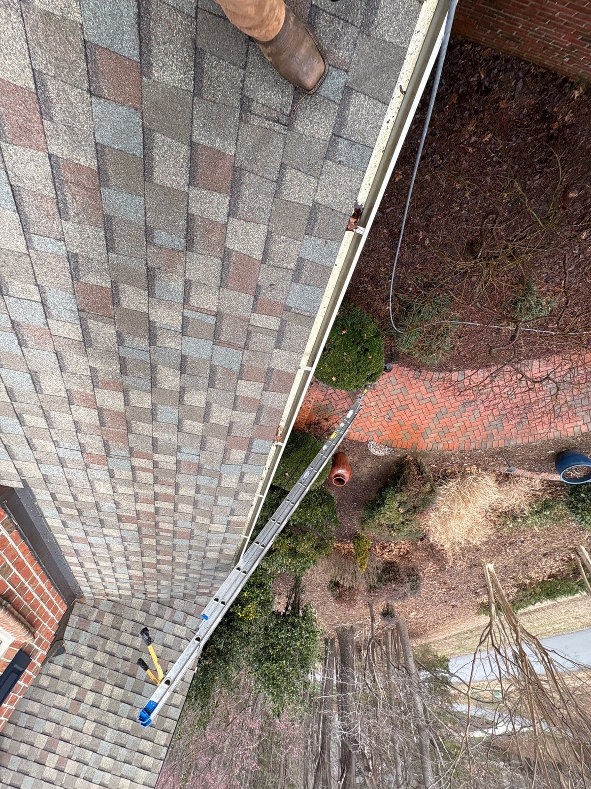 Exterior residential gutter cleaning and downspout debris removal