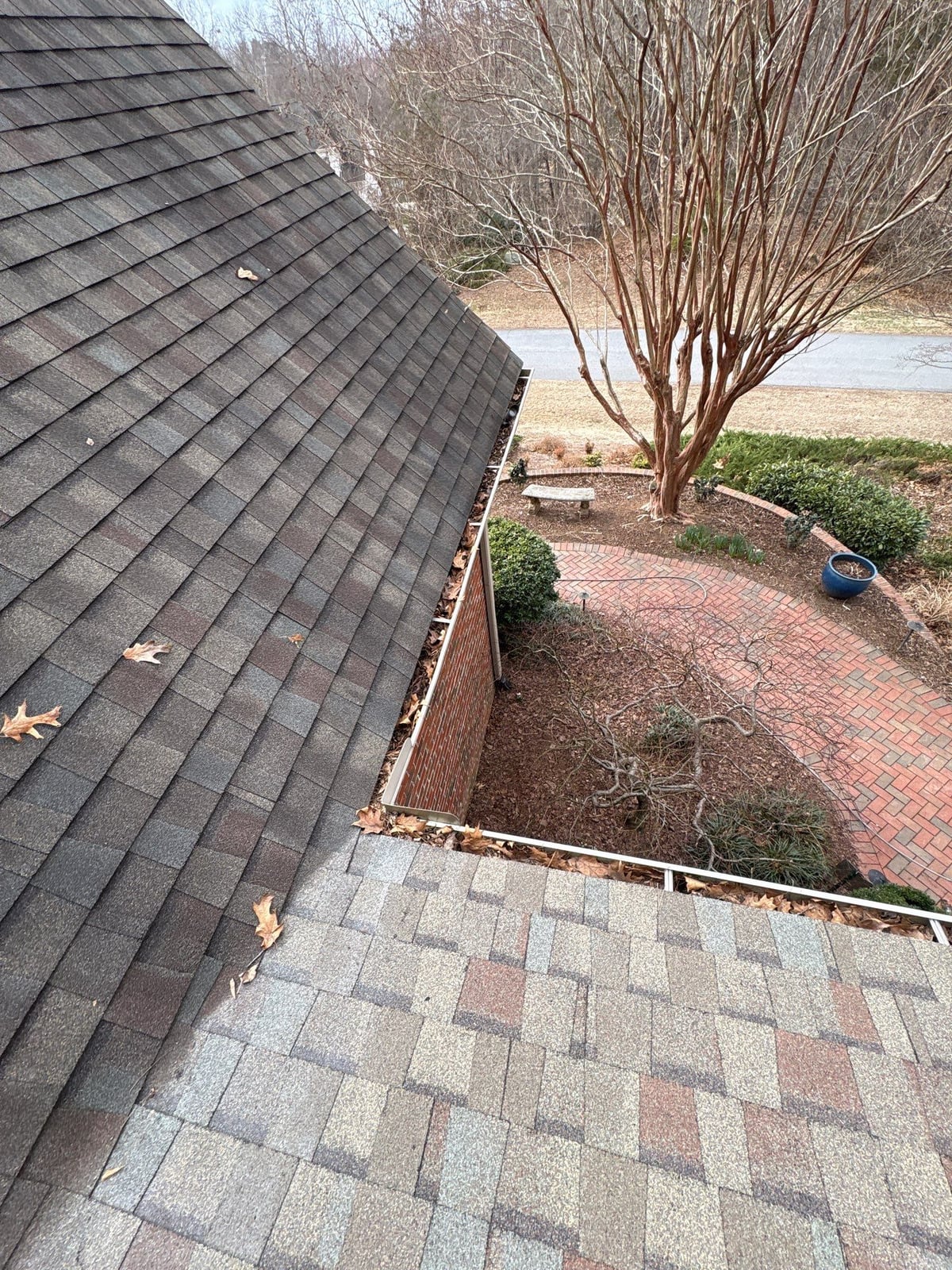 Exterior residential gutter cleaning and downspout debris removal
