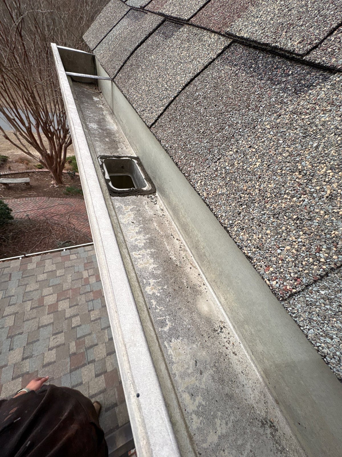 Exterior residential gutter cleaning and downspout debris removal