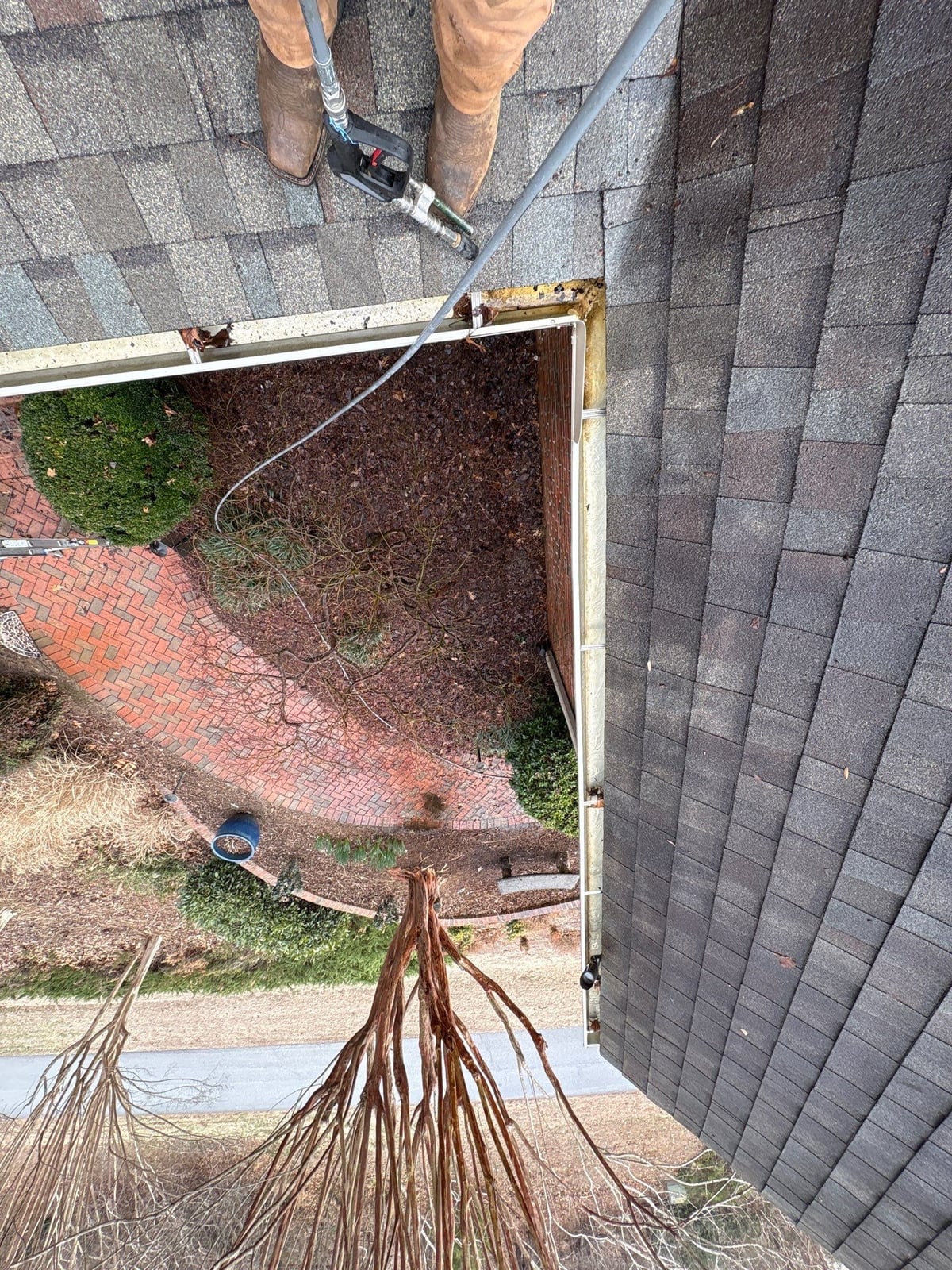 Exterior residential gutter cleaning and downspout debris removal