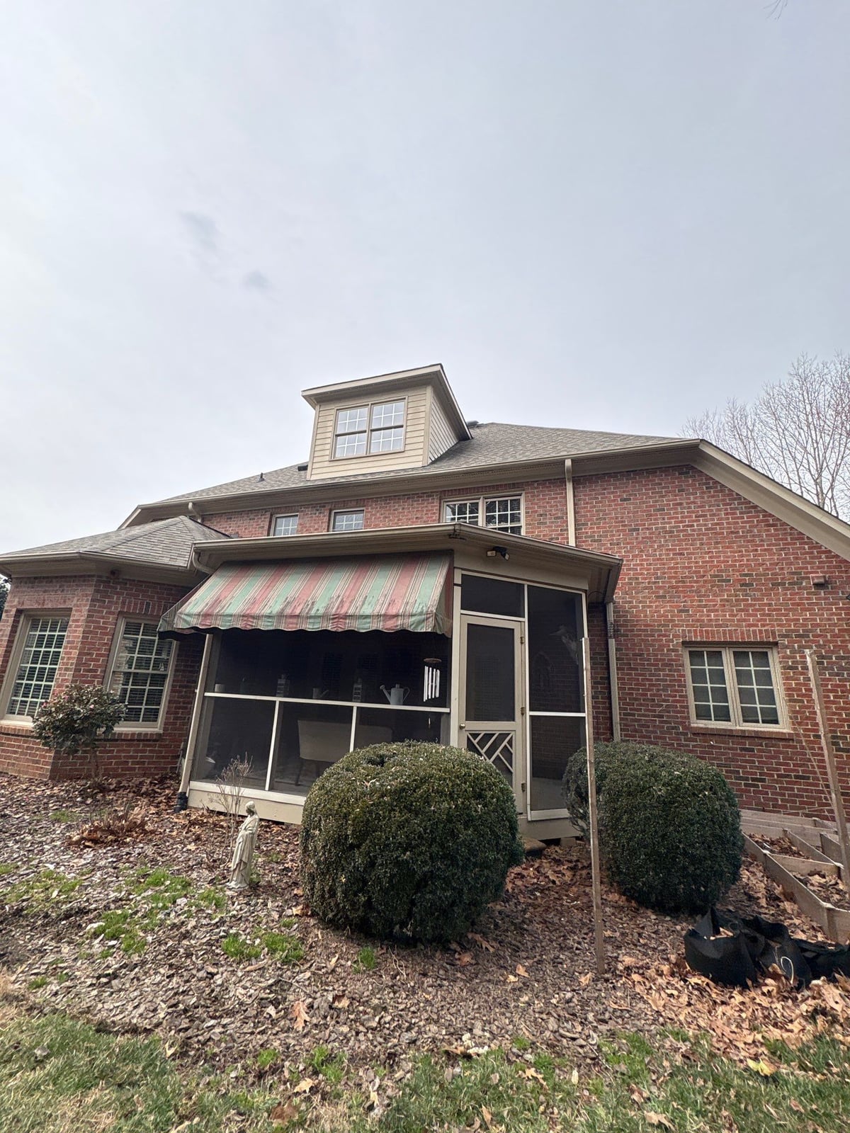 Exterior residential gutter cleaning and downspout debris removal