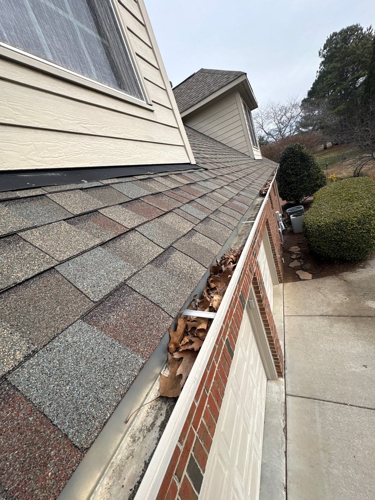 Exterior residential gutter cleaning and downspout debris removal
