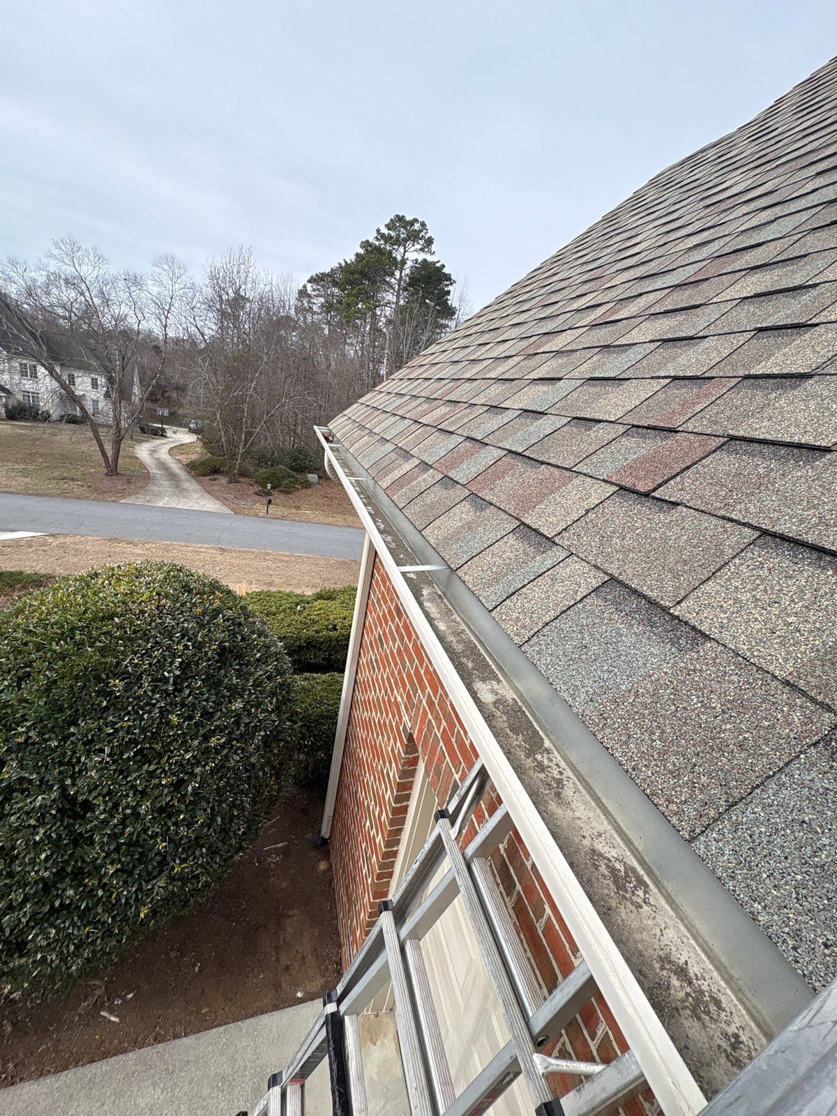 Exterior residential gutter cleaning and downspout debris removal