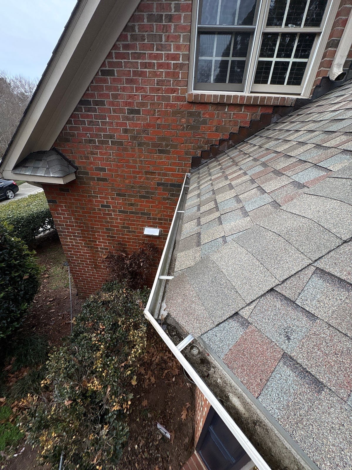 Exterior residential gutter cleaning and downspout debris removal